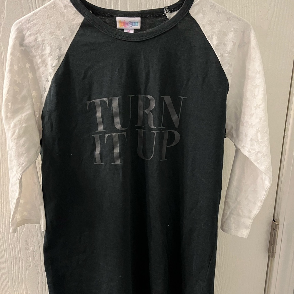 LuLaRoe Randy size Medium. Black with white burn out sleeves. Says turn it up.